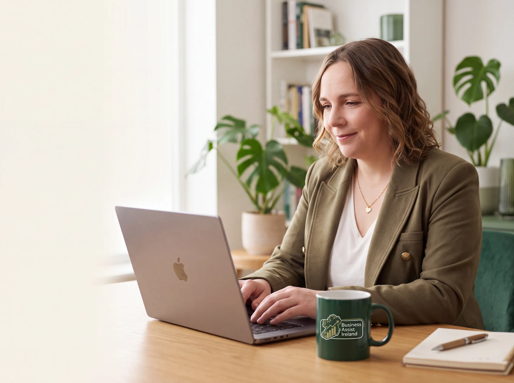Hazel Tully working at a laptop for Business Assist Ireland